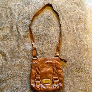 Ladies Union Bay cognac crossbody with front braid and buckle detail